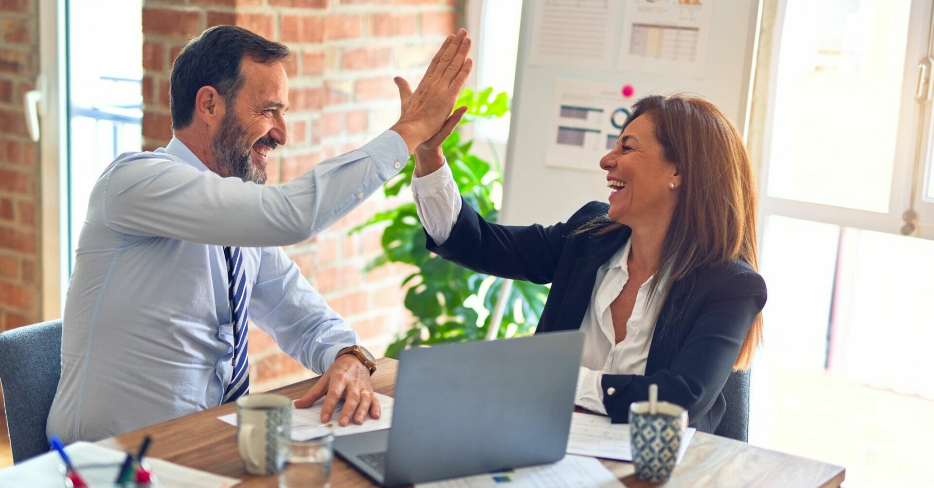 Colleagues high-fiving - How to Be More Positive
