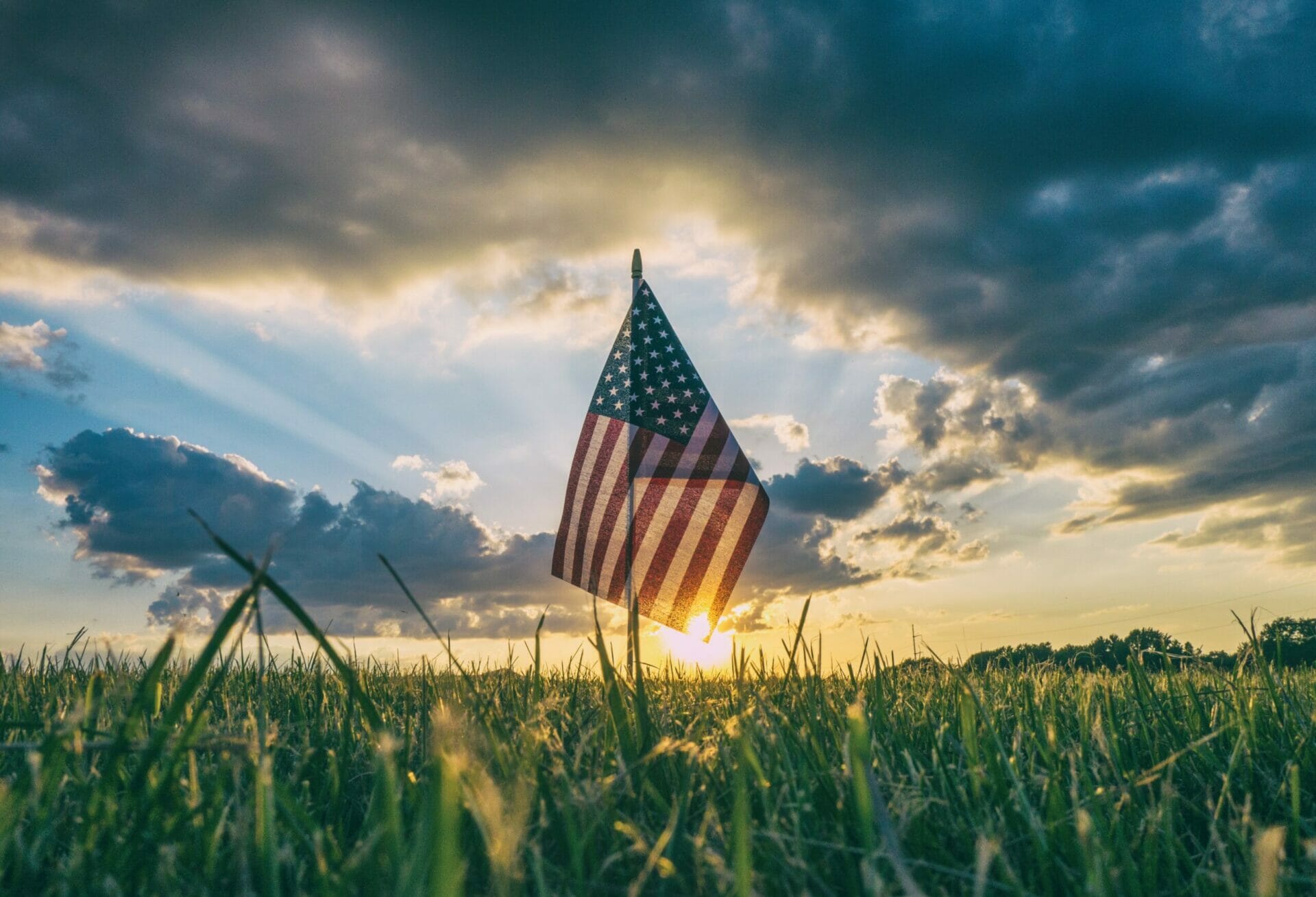 Tiny American flag stuck in the grass - A Patriot’s View on Independence Day