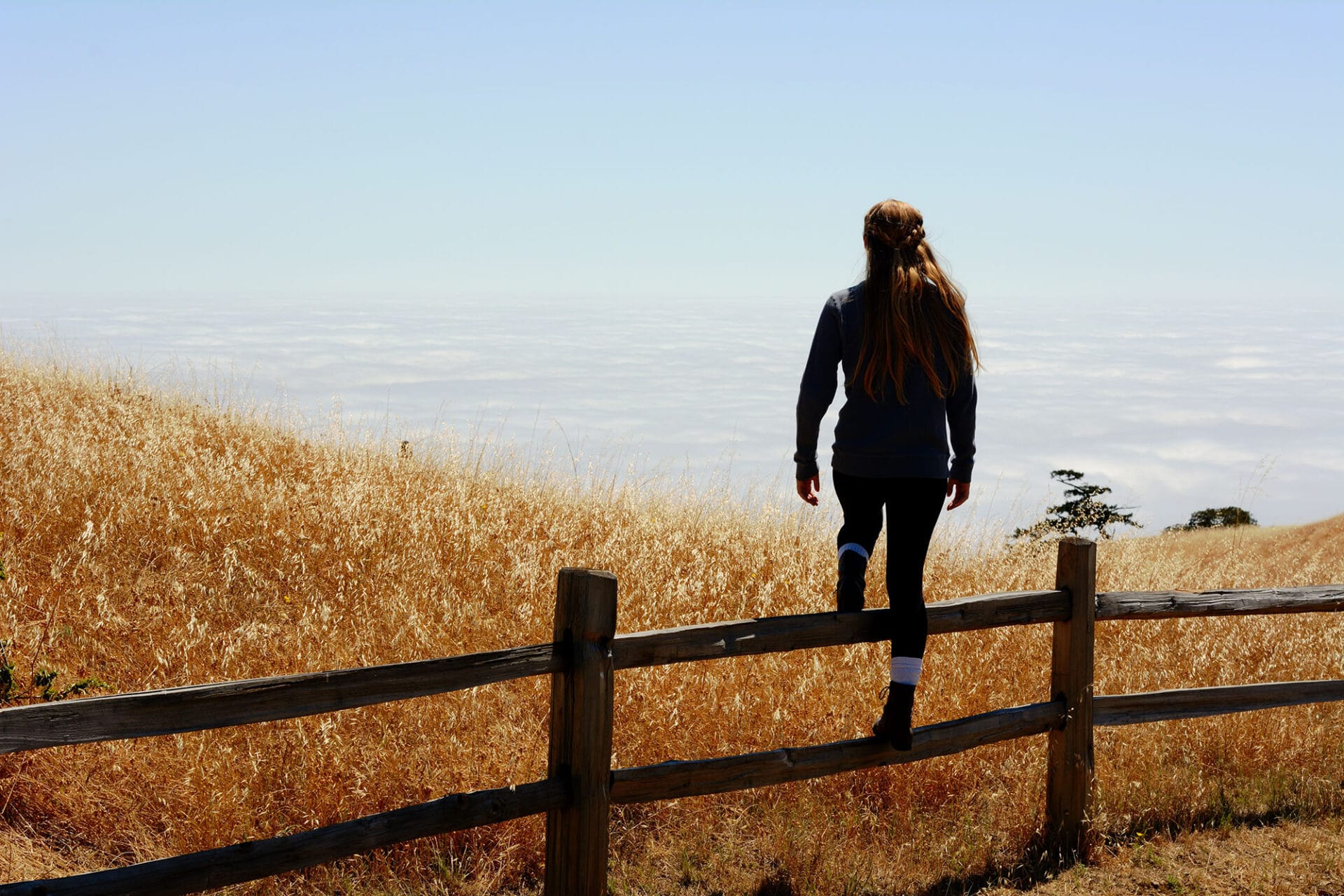 Woman looking out over a fence - How to Be the Main Character in Your Life, a soft power series session by Angie Witkowski