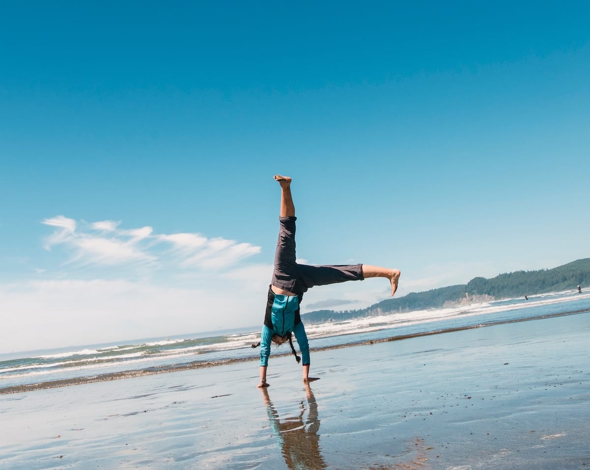 Person doing a cartwheel on the the beach