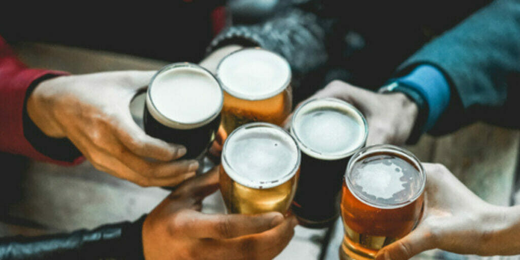 people cheering to beers - Are You in a Toxic Relationship with Recognition?