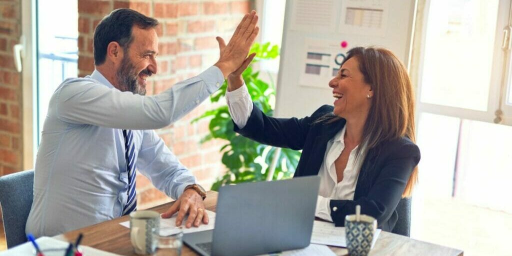 Colleagues high-fiving - How to Be More Positive