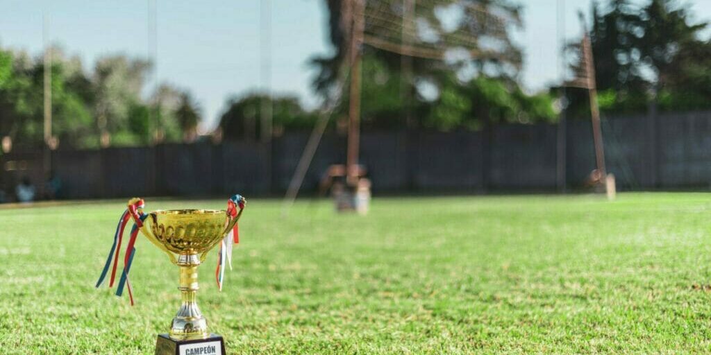 Trophy next to a Volley Ball Net - The Imposter Syndrome and Its Antidote