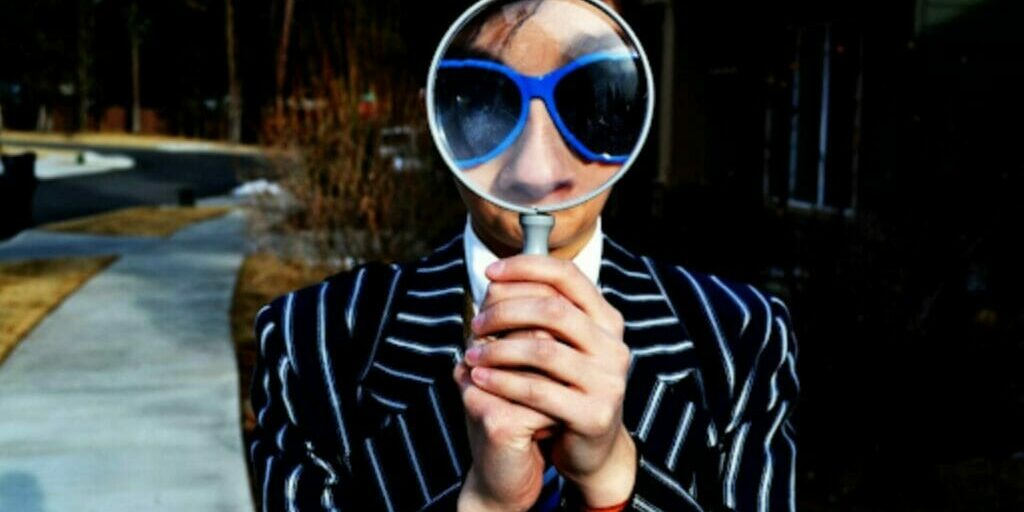 Magnifying glass held up to someone's face. Why Self-Awareness is Important in Leadership Development